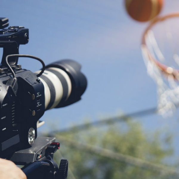 Video camera filming basketball shot